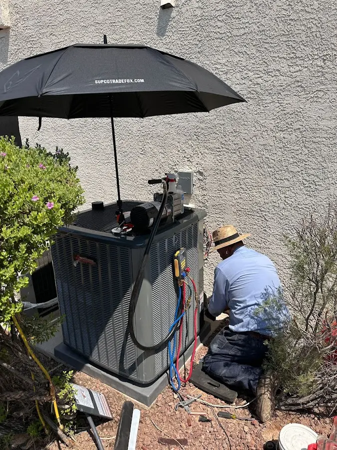 HVAC technician performing outdoor AC maintenance in Homer